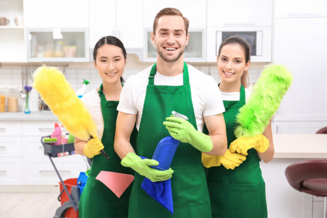 Cleaning service team at work in kitchen
